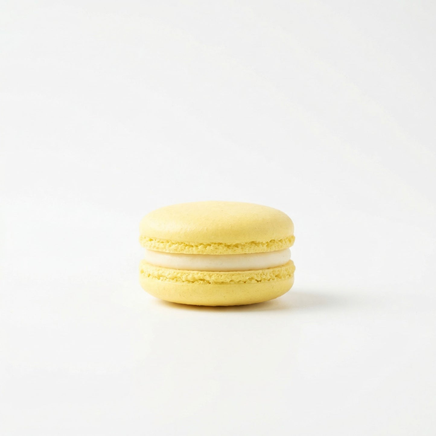 Lemon macaron on white background