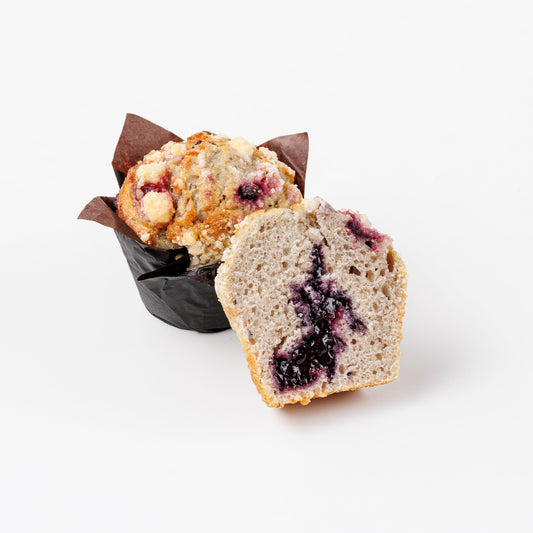 Blueberry Muffin cut in half on a white background