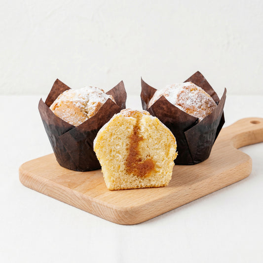 Carame muffins with caramel filling on wooden board