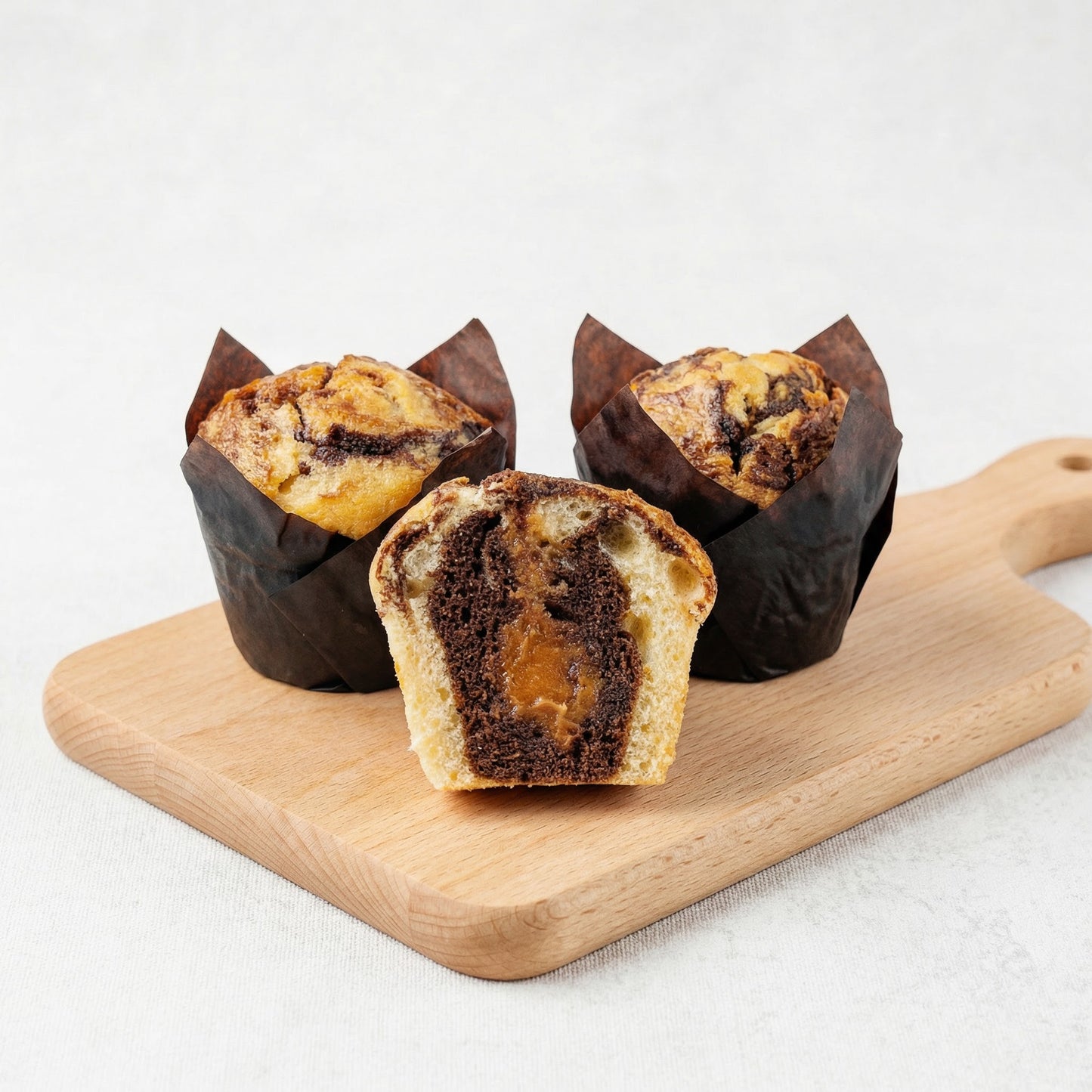 Chocolate Marble Muffin with Caramel Filling on Wooden Board