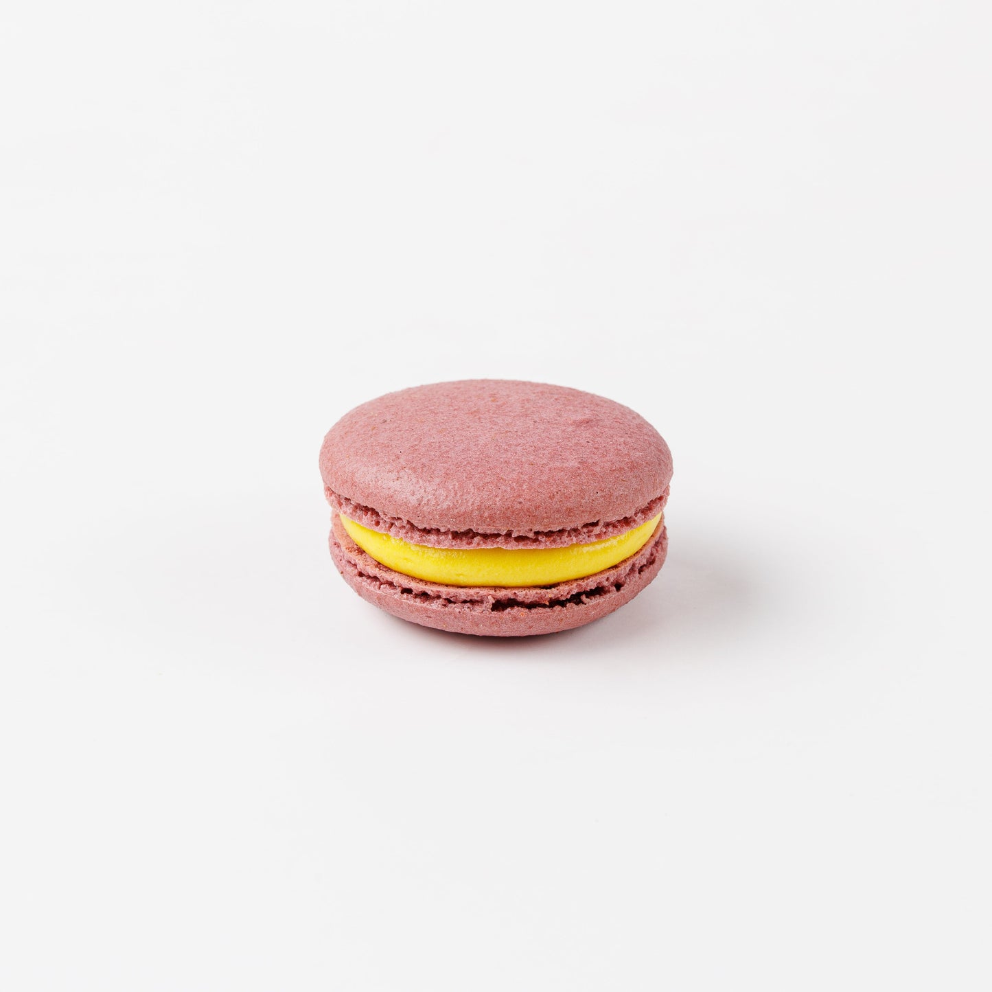 Purple Passion Fruit Macaron on white background