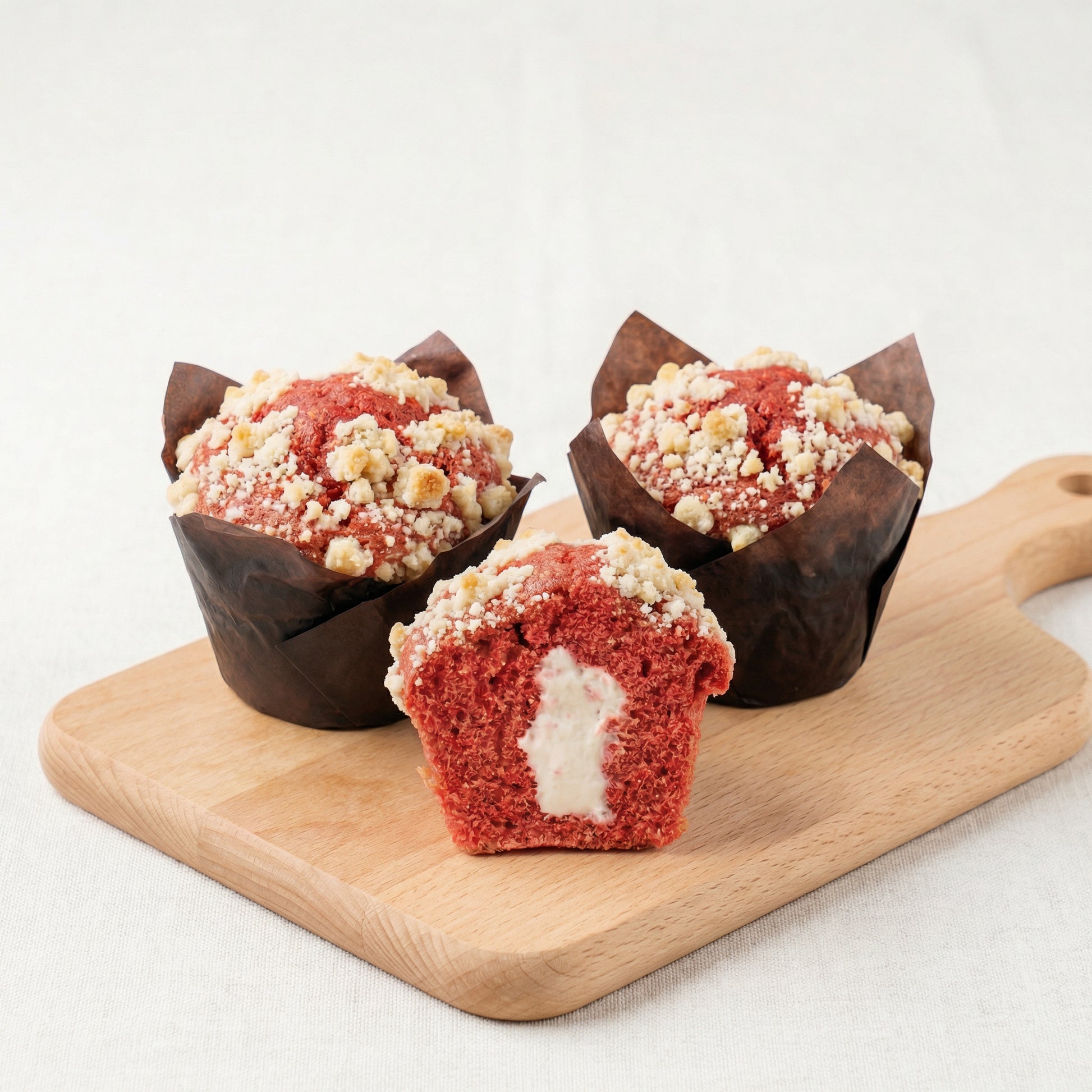 Red Velvet Muffin with cream cheese filling on wooden board