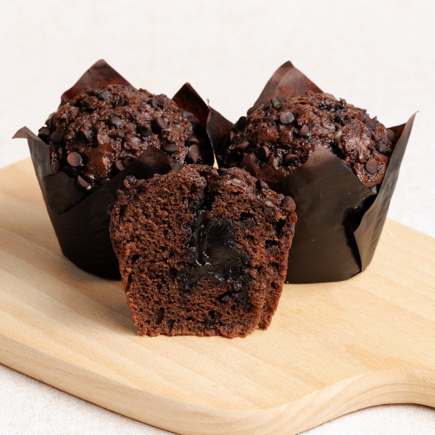 Chocolate muffins on a wooden board