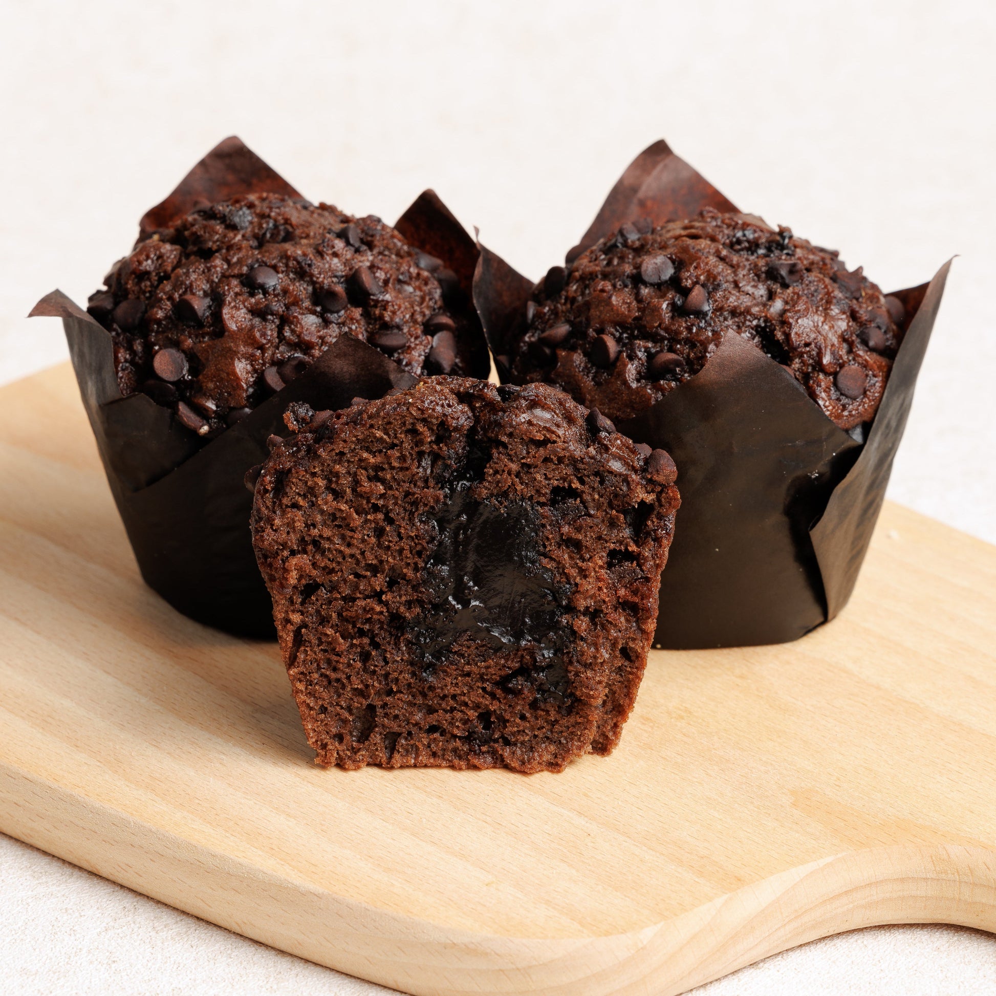 Chocolate muffins on a wooden board